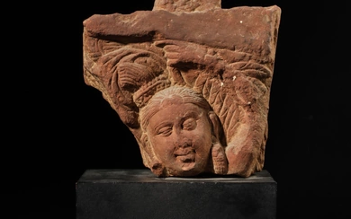 A mottled red sandstone Yakshini head, Central India, Mathura, 2nd century