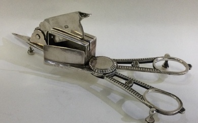 A pair of George III silver candle snuffers.