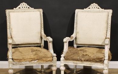 A pair of Louis XVI Revival painted armchairs, carved throug...
