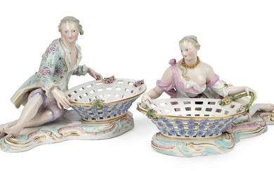 A pair of Meissen porcelain figural sweetmeat baskets, late 19th century, blue crossed swords marks, incised numerals, black 43 marks, modelled as a young man and a young woman reclining by large oval pierced baskets, on plinth bases edged with...