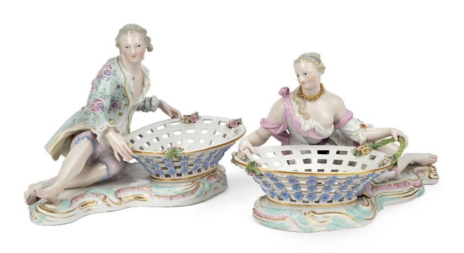 A pair of Meissen porcelain figural sweetmeat baskets, late 19th century, blue crossed swords marks, incised numerals, black 43 marks, modelled as a young man and a young woman reclining by large oval pierced baskets, on plinth bases edged with...