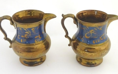 A pair of Victorian copper lustre ware jugs with banded