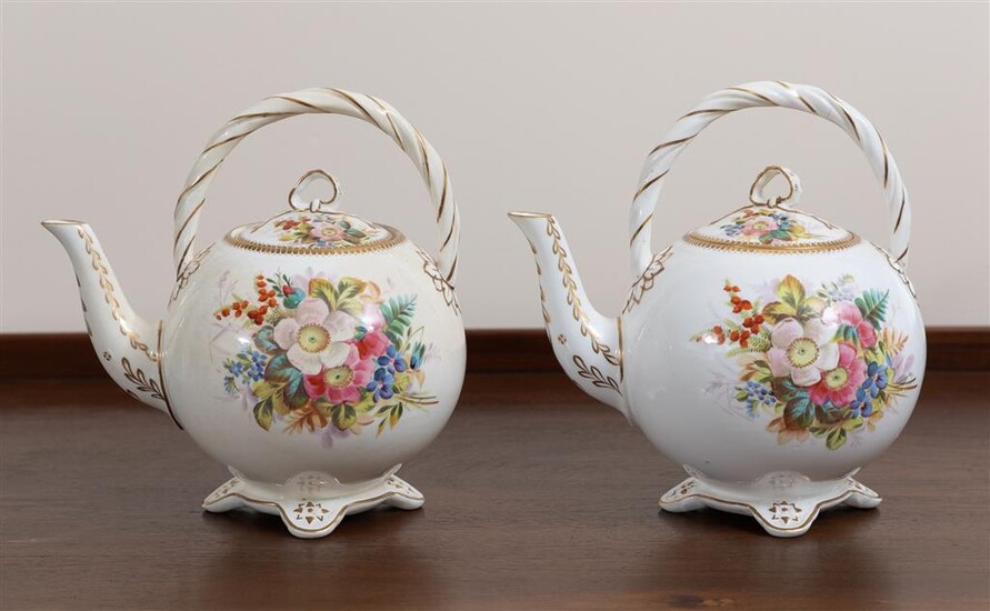 A pair of fine porcelain teapots with gilt highlights and...