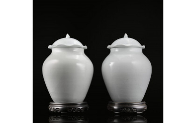 A pair of white-glazed "lotus" jars and covers (defects) China, 19th century (h. 38 ca cm.) For a similar lot...