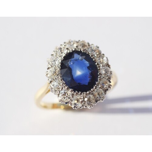 A sapphire and diamond cluster ring, the central oval, mixed...