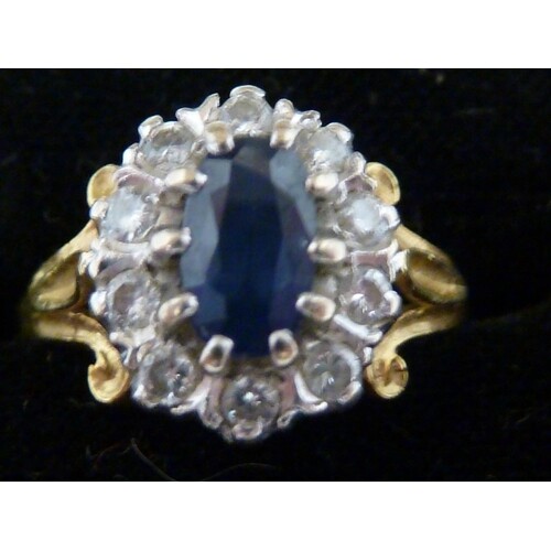 A sapphire and diamond set 18ct yellow gold ring, the oval s...