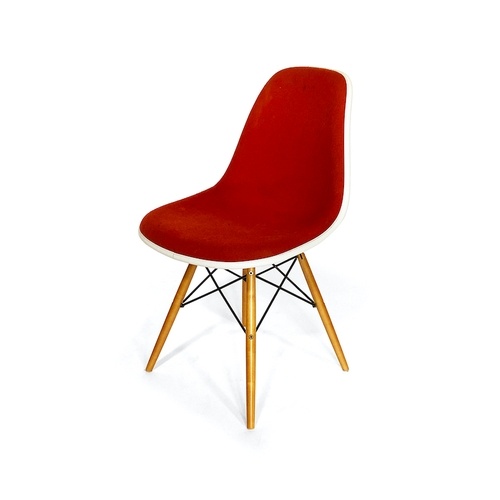 A set of eight Vitra Eames DSW chairs With red upholstery an...