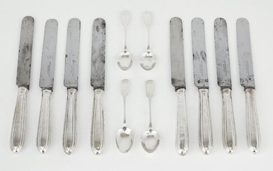 A set of eight silver handled table knives, marks rubbed, maker R.T, with steel blades and engraved crest to terminals (rubbed), together with four Irish George IV silver fiddle pattern teaspoons, Dublin, c.1823, Joshua Buckton, terminals engraved...