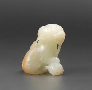 A white and russet jade 'Buddhist lion' carving