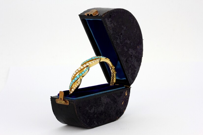 A yellow metal (tested 15ct gold) bangle set with cabochon cut turquoise and pearls, in an antique bangle box, L. 6.5cm.