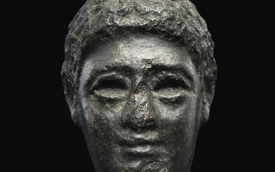AN EGYPTIAN BASALT HEAD OF A MAN, LATE PTOLEMAIC PERIOD, CIRCA 100-30 B.C.