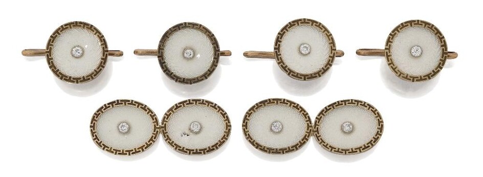 An Art Deco gold, diamond and enamel dress set, comprising a pair of cufflinks, designed as oval pale blue guilloche enamel panels with central old-brilliant-cut diamond with engraved key pattern borders, and four matching circular dress buttons...
