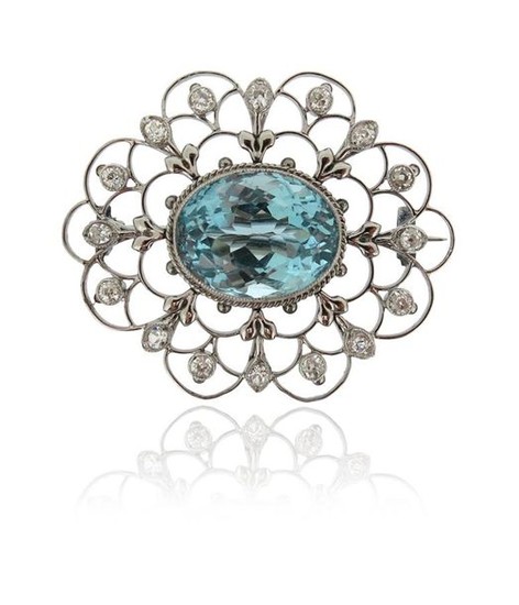 An aquamarine and diamond brooch, the oval-shaped aquamarine...