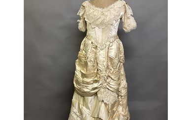 An elaborate 1880’s wedding or evening gown, skirt with inte...