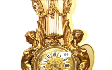 An impressive French gilt brass classical mantle clock with enamelled porcelain numerals, c.1900, H. 71cm.