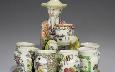 An unusual porcelain figure of a Chinese vase seller, probably French, late 19th century, modelled a