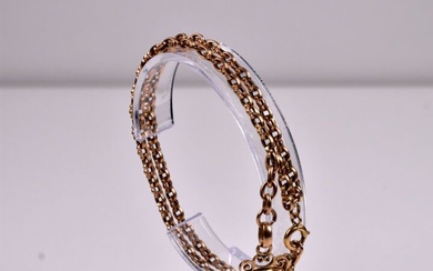 Bracelet double rang et sa breloque en or rose 18k 750/1000e et petites perles (manques)....