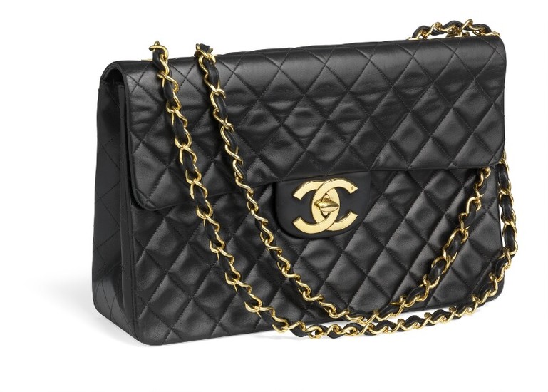 Chanel: A “Maxi Jumbo Flap Bag” of black quilted leather, golden hardware, CC turn lock and double chain strap.