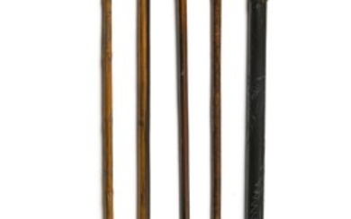 FIVE CARVED WOODEN CANES Two with metal collars. Lengths from 34" to 36".