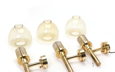 Hans-Agne Jakobsson: Three brass wall lamps with pierced pattern and shades of smoke coloured glass. H. 35 cm. (3)