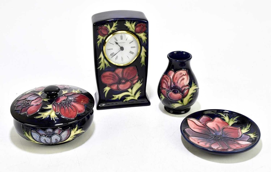 MOORCROFT; four 'Anemone' pattern items, comprising a timepiece, bowl and...