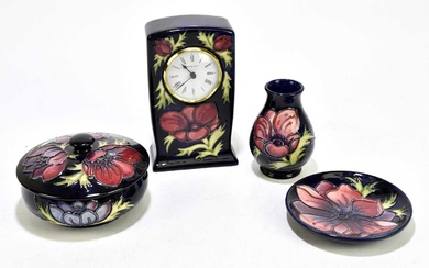 MOORCROFT; four 'Anemone' pattern items, comprising a timepiece, bowl and...