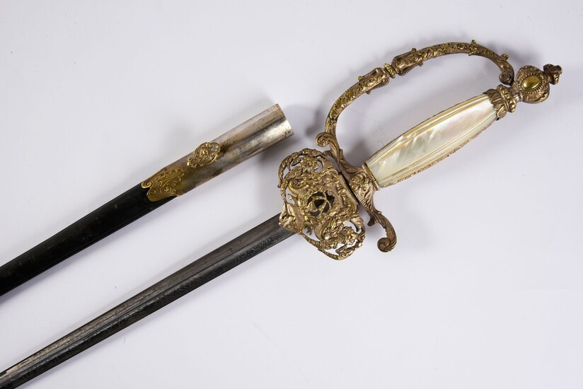 PREFET HENRI GOULLEY'S APPARAT Sword.Silver plated metal frame, with carved decoration of floral motifs, arabesques and leafy garlands. Fuse in mother-of-pearl plates. Triangular steel blade engraved with foliage on its first third, preserved with...