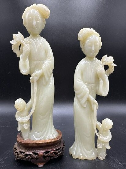 Pair of yellow jade guanyin,one has wood stand
