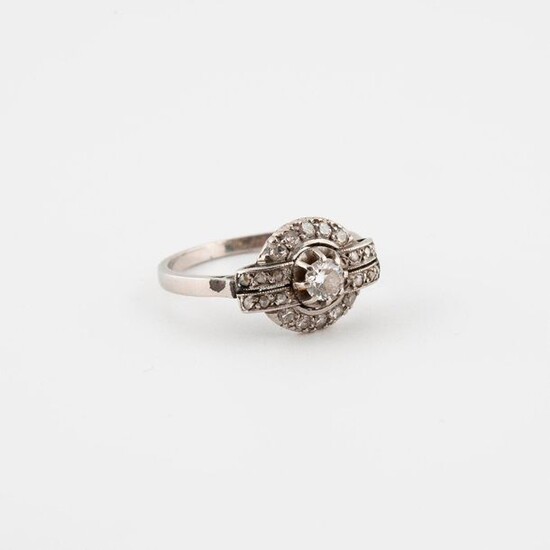 Platinum ring (850) set with a half-cut diamond in claw setting in a ring of rose-cut diamonds in grain setting.