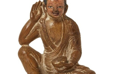 Property of a Gentleman (lots 36-85) A Tibetan carved hardstone figure of a monk, 18th/19th century, seated on a lotus base with his right hand held to his ear and his left clutching an alms bowl in his lap, his hair and features finely detailed...