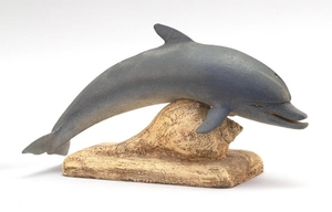 ROBERT INNIS DOLPHIN CARVING Mounted on a carved conch shell base. Signed on underside of base "Dolphin By Robert I. Innis So. Denni...