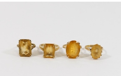 Six 9 carat gold single stone rings, set with smokey quartz ...