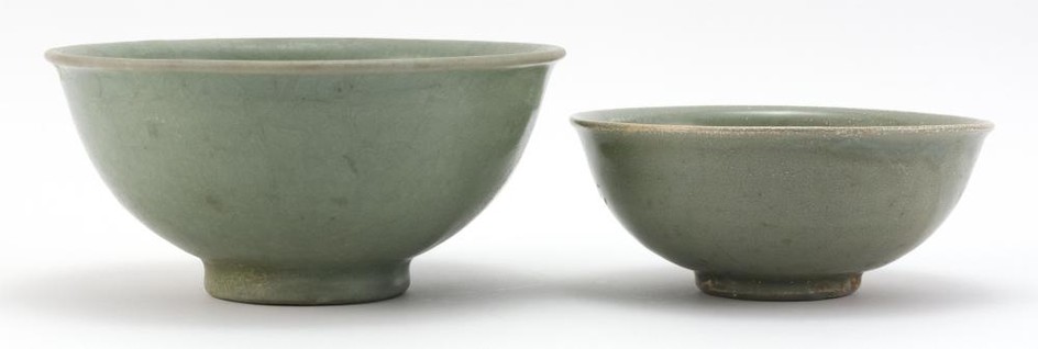 THREE CHINESE BOWLS 1-2) Two celadon stoneware bell-form bowls, one with incised wave design. Diameters 6.75" and 8.25". 2) Blue and...