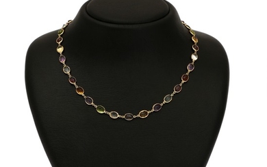 A multi coloured necklace set with numerous oval-cut peridots, amethysts, citrines, aquamarines, garnets and quartz, mounted in 18k gold. L. 45.5 cm.