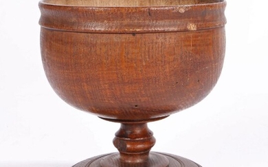19th Century ash treen goblet, the wide bowl above a turned stem and ring turned circular foot, 12.