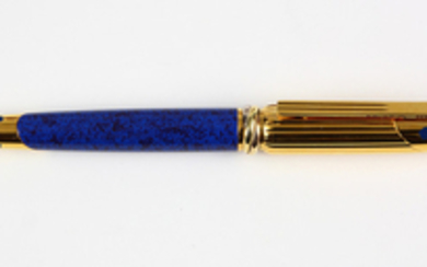 Must de Cartier Panthere roller ball pen, having a yellow gold plated body accented with a lapis blue lacquer in the "Panthere" moti...