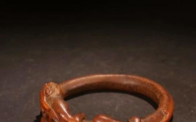 A BAMBOO CARVED BANGLE WITH DRAGON PATTERN