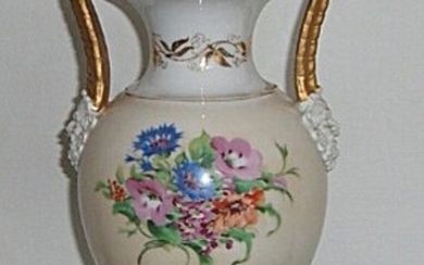 A Bing & Groendahl porcelain vase, decorated in colours and gold with flowers, masks by handles. 19th century. H. 35 cm.