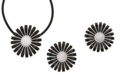 A black enamel ‘Daisy’ pendant and earclips, by...