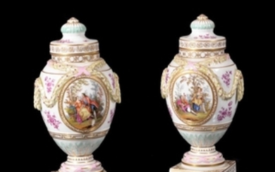 A pair of Dresden porcelain urns and covers