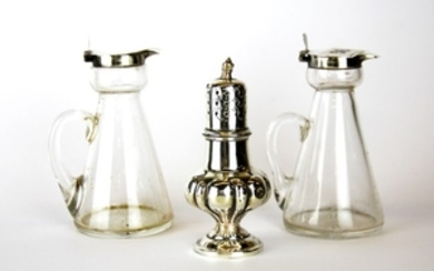 A pair of hallmarked silver topped glass jugs and a hallmarked silver pepperette, H. 10cm.