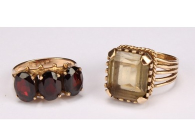 A 9ct gold ring set with a single faceted rectangular smoky ...