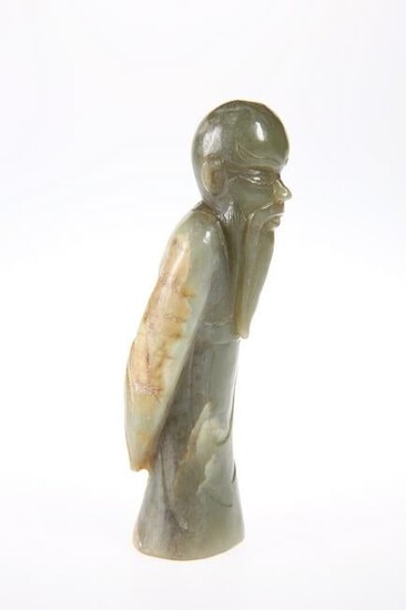 A CHINESE JADE FIGURE, carved as a scholar, standing