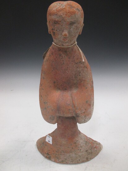 A Chinese red pottery standing lady attendant, probably Han Dynasty, 31.5cm high