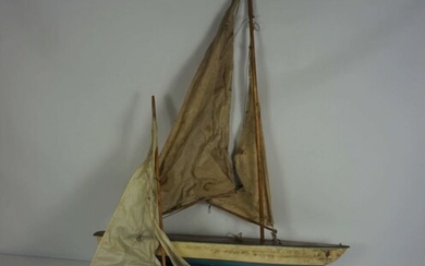 A ‘Clyde Model Dockyard’ small toy sailing boat, and another toy tin plate sailboat, inscribed to
