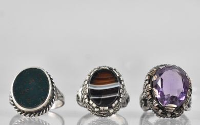 A Collection of Three Silver and White Metal Rings to includ...