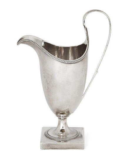 A George III silver helmet-shaped cream jug by Hester Bateman, London, c.1787, designed with an elongated loop handle and beaded edge, the jug raised on a square plinth base, 16.2cm high, approx. weight 4.2oz