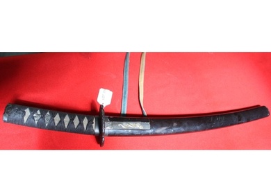 A Japanese sword with shagreen handle cord wrapped. Cast Tsu...
