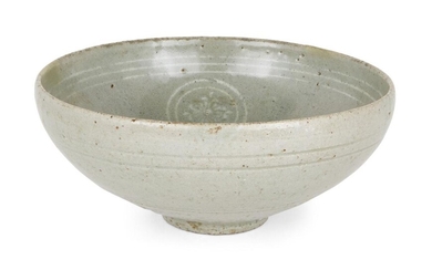 A Korean stoneware inlaid celadon bowl, Goryeo dynasty, 13th-14th century, on short foot with curved sides, the interior inlaid with white slip with four roundels, each enclosing a flowerhead, all beneath a band of three concentric circles, 17cm...
