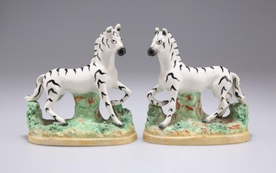 A PAIR OF 19TH CENTURY STAFFORDSHIRE POTTERY ZEBRAS